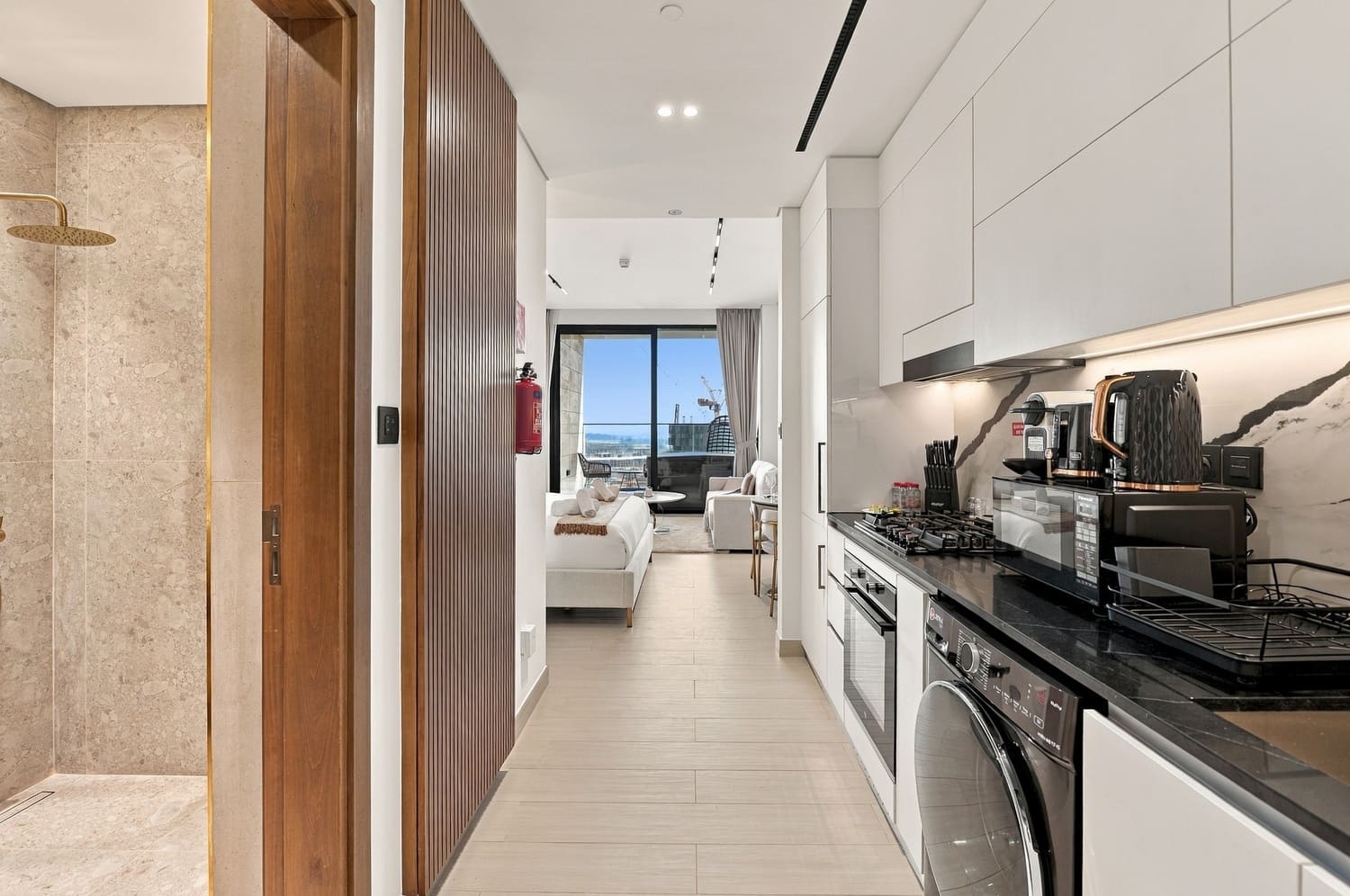 Luxury studio apartment interior at Trillionaire Residences By Binghatti Business Bay Dubai with daytime window illumination