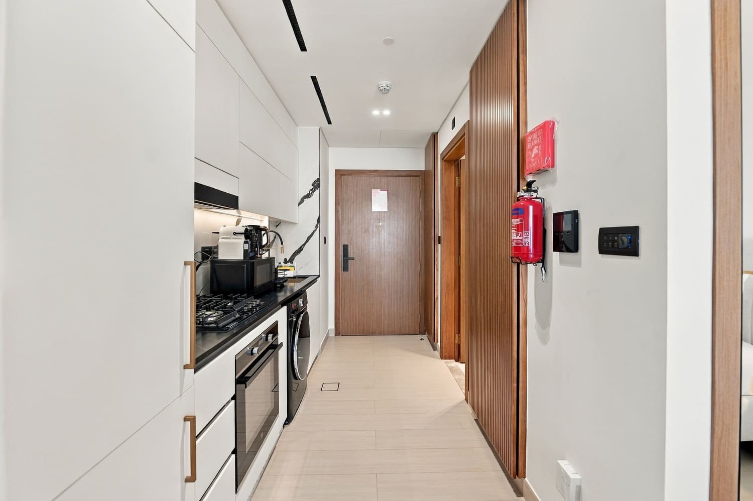 Modern integrated kitchenette and dining island in Trillionaire Residences studio apartment