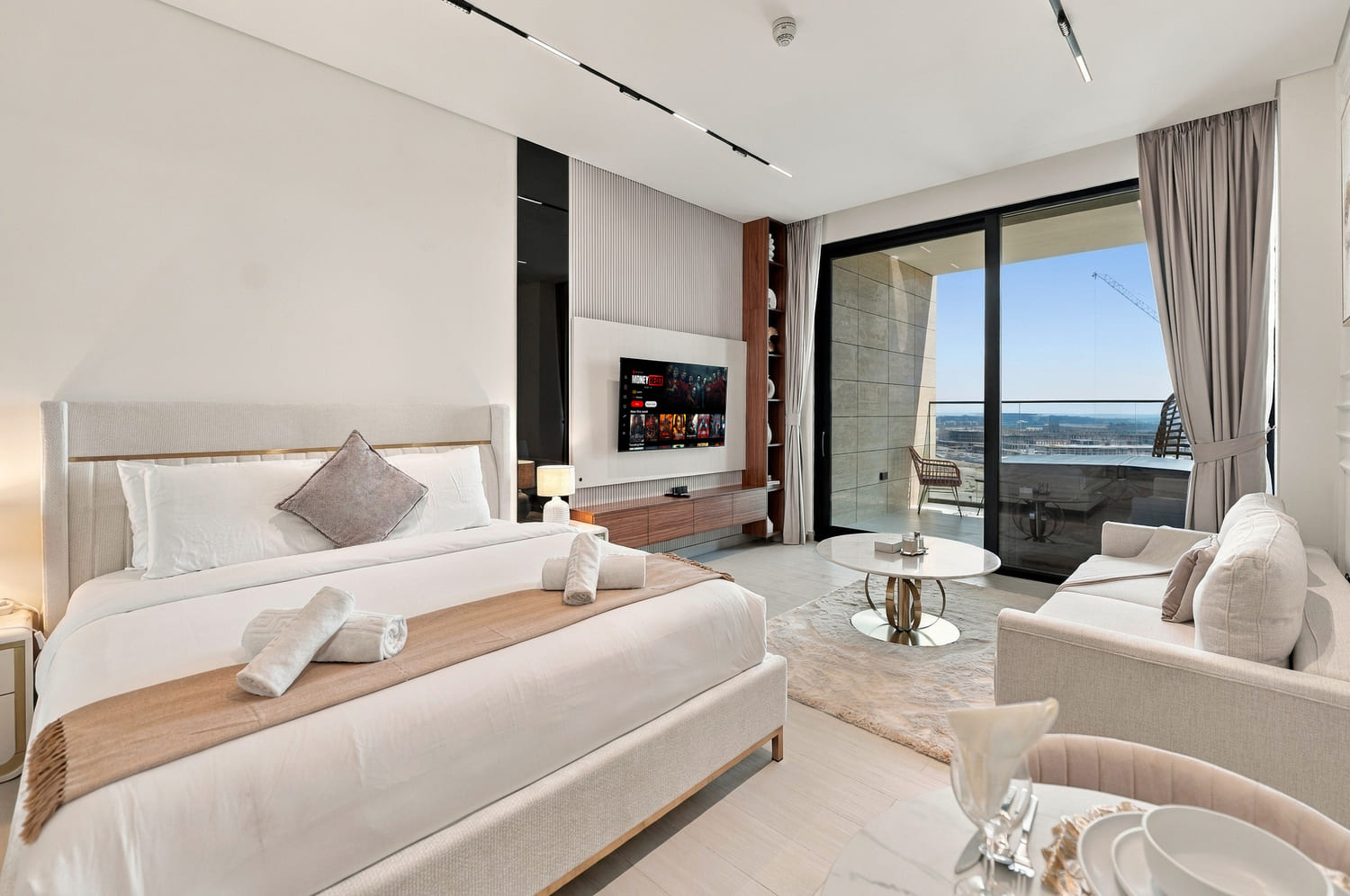 Floor-to-ceiling window perspective framing natural sunlight and luxury furnishings in Trillionaire studio
