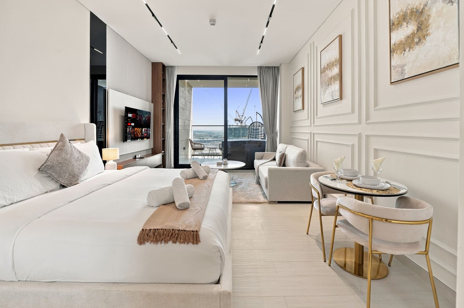 Studio living perspective showcasing designer wall panelling, ambient lighting, and smart entertainment center