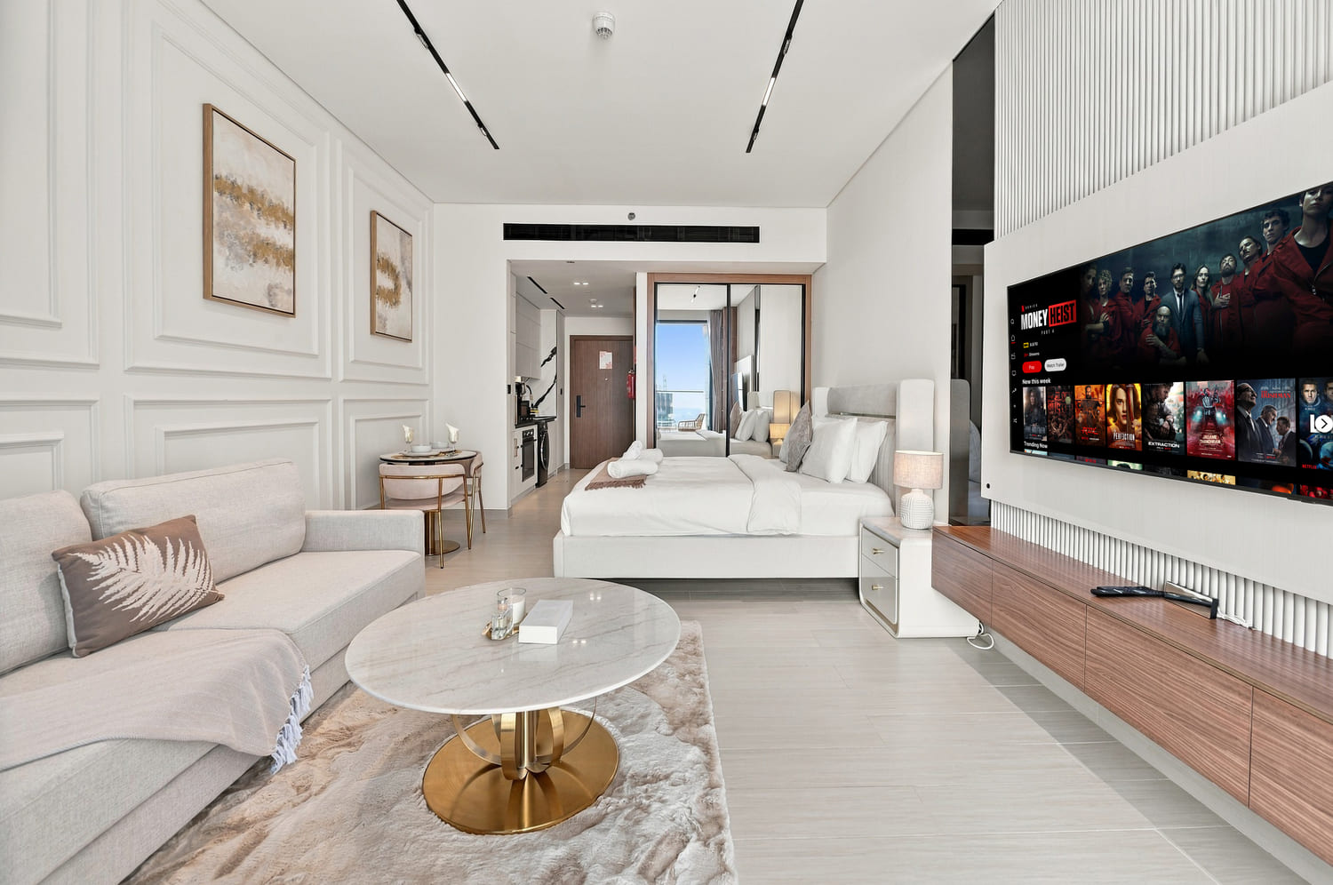 Dining bar setup with designer stools and warm ambient pendant lighting in luxury studio