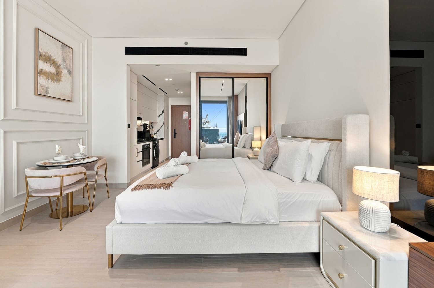 Full-height porcelain marble slabs and designer sanitary ware in luxury studio bathroom