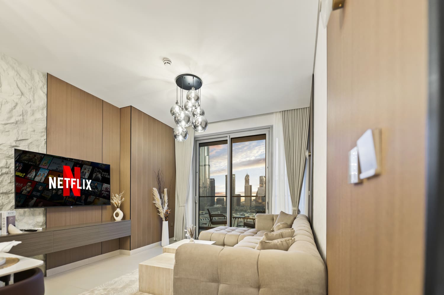 Warm hospitality lighting and modern dining furniture in Vida Tower 2 Dubai Mall holiday apartment