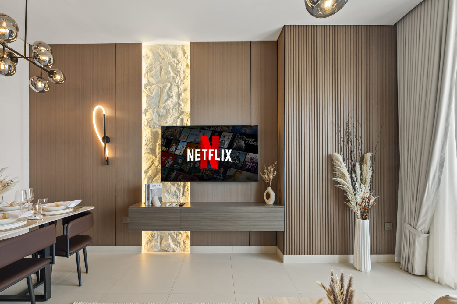 Modern living room media wall, smart TV setup, and plush sofa at Vida Tower 2 Dubai Mall apartment