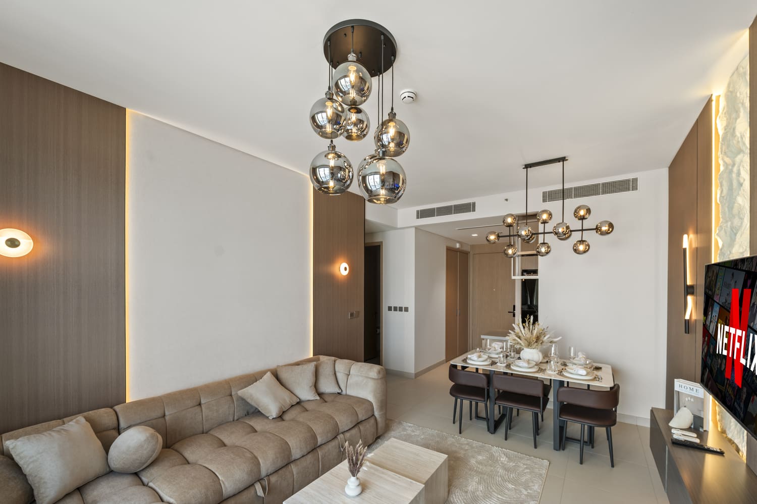 Expansive living room and dining table arrangement with natural window light at Vida Tower 2 Dubai Mall