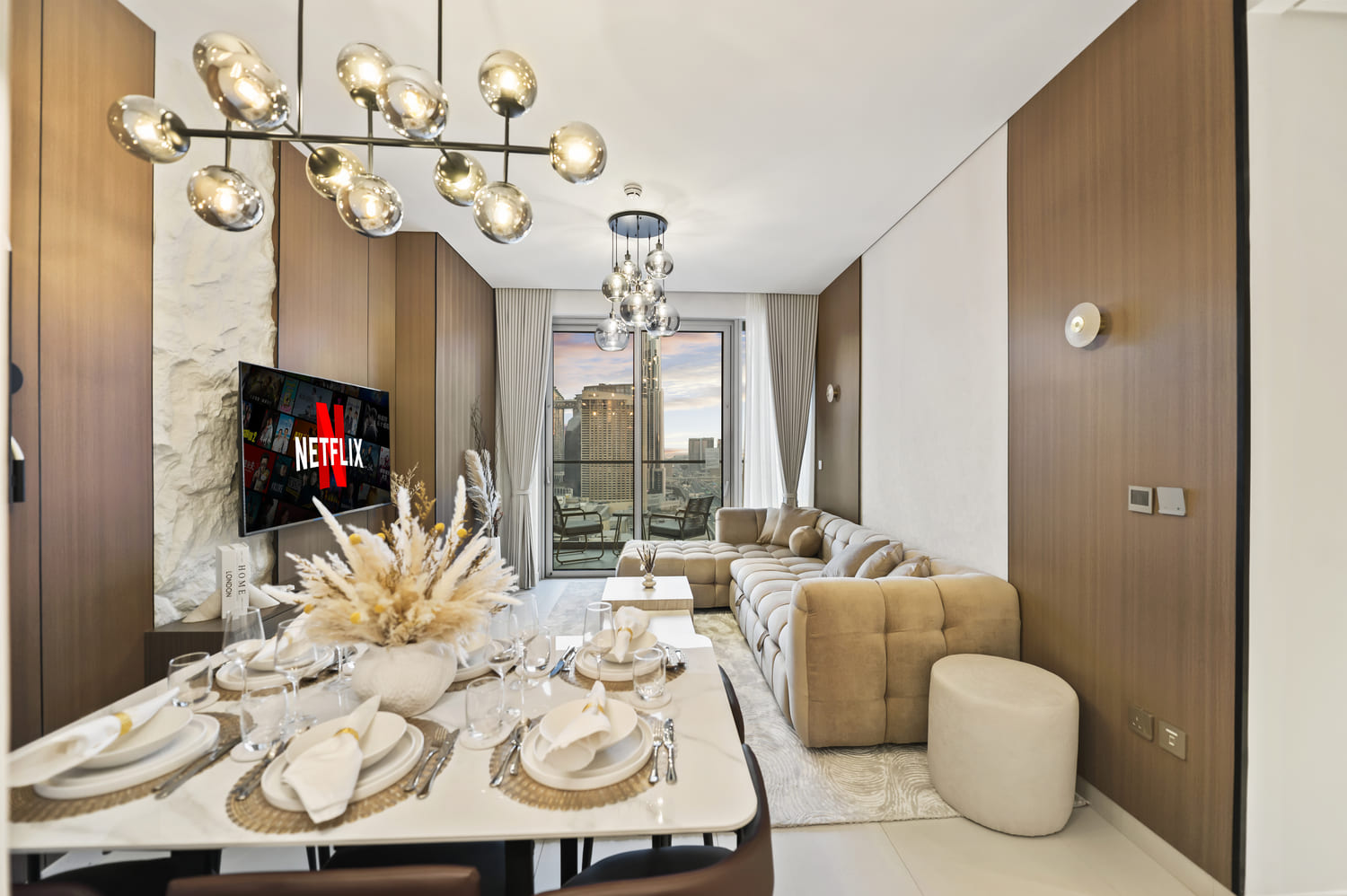 Styled dining table arrangement with upholstered chairs and tableware at Vida Tower 2 Dubai Mall