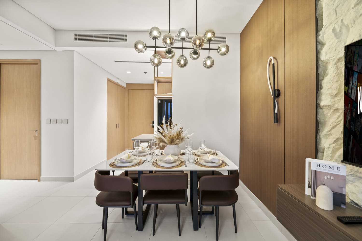 Designer dining table vignette positioned beside floor-to-ceiling windows at Vida Tower 2 Dubai Mall