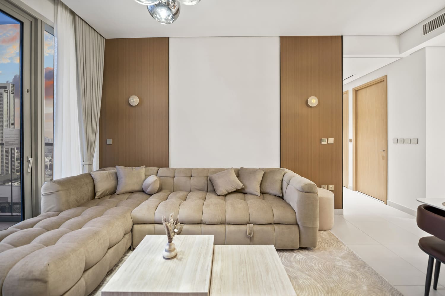 Plush L-shaped lounge sofa and textured throw pillows in Vida Tower 2 Dubai Mall vacation rental