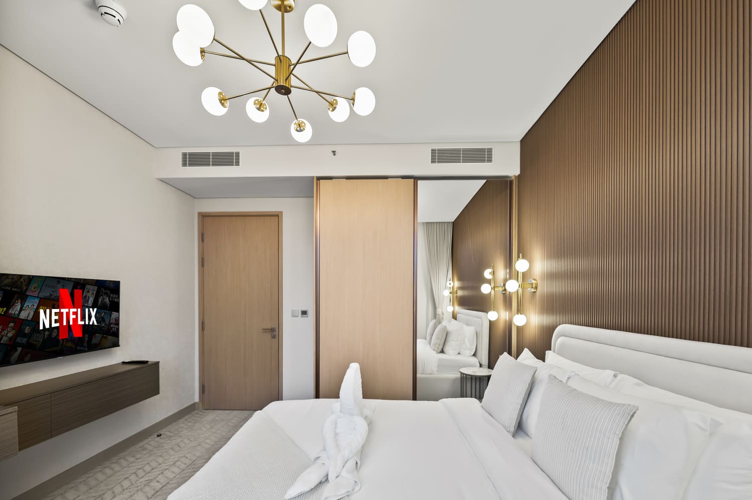 Master bedroom suite with king bed, crisp hotel linens, and daylight window at Vida Tower 2 Dubai Mall