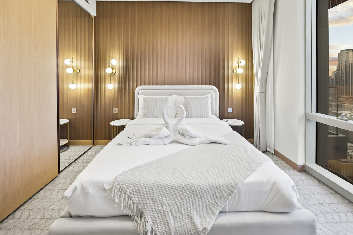 Crisp white Egyptian cotton bedding and decorative pillows in Vida Tower 2 Dubai Mall holiday home