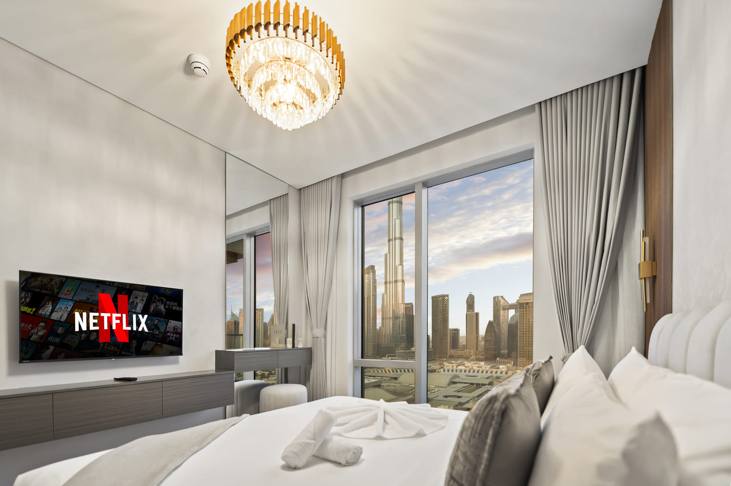 Editorial angle of luxury bedding, runner throw, and bedside pendant at Vida Tower 2 Dubai Mall