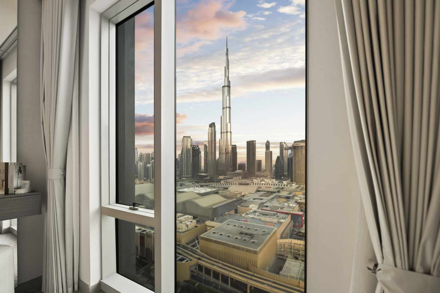 Luxury bedroom floor-to-ceiling corner window overlooking Downtown Dubai skyline at Vida Tower 2 Dubai Mall
