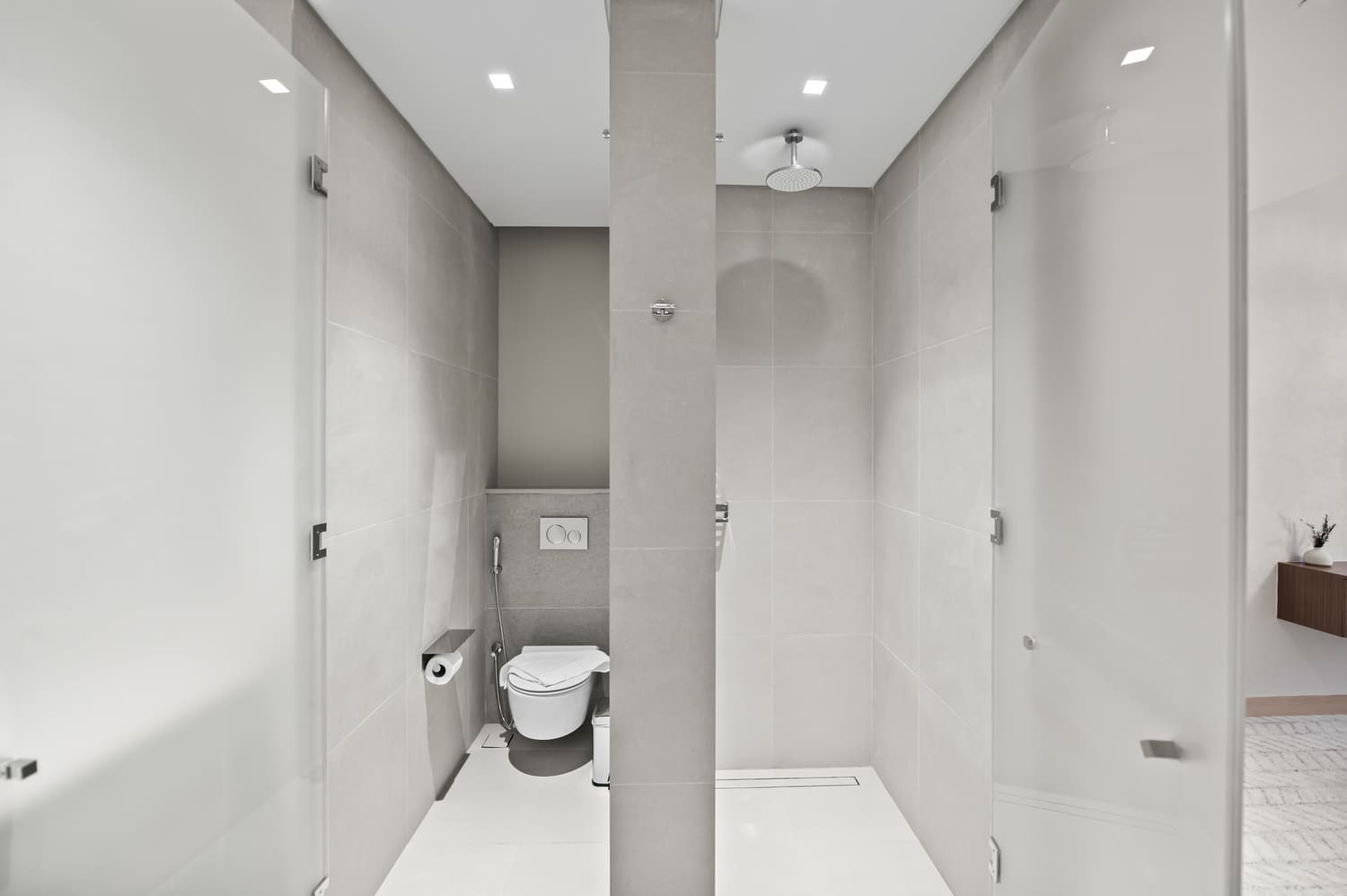 Luxury marble en-suite bathroom with illuminated vanity mirror and soaking tub at Vida Tower 2 Dubai Mall