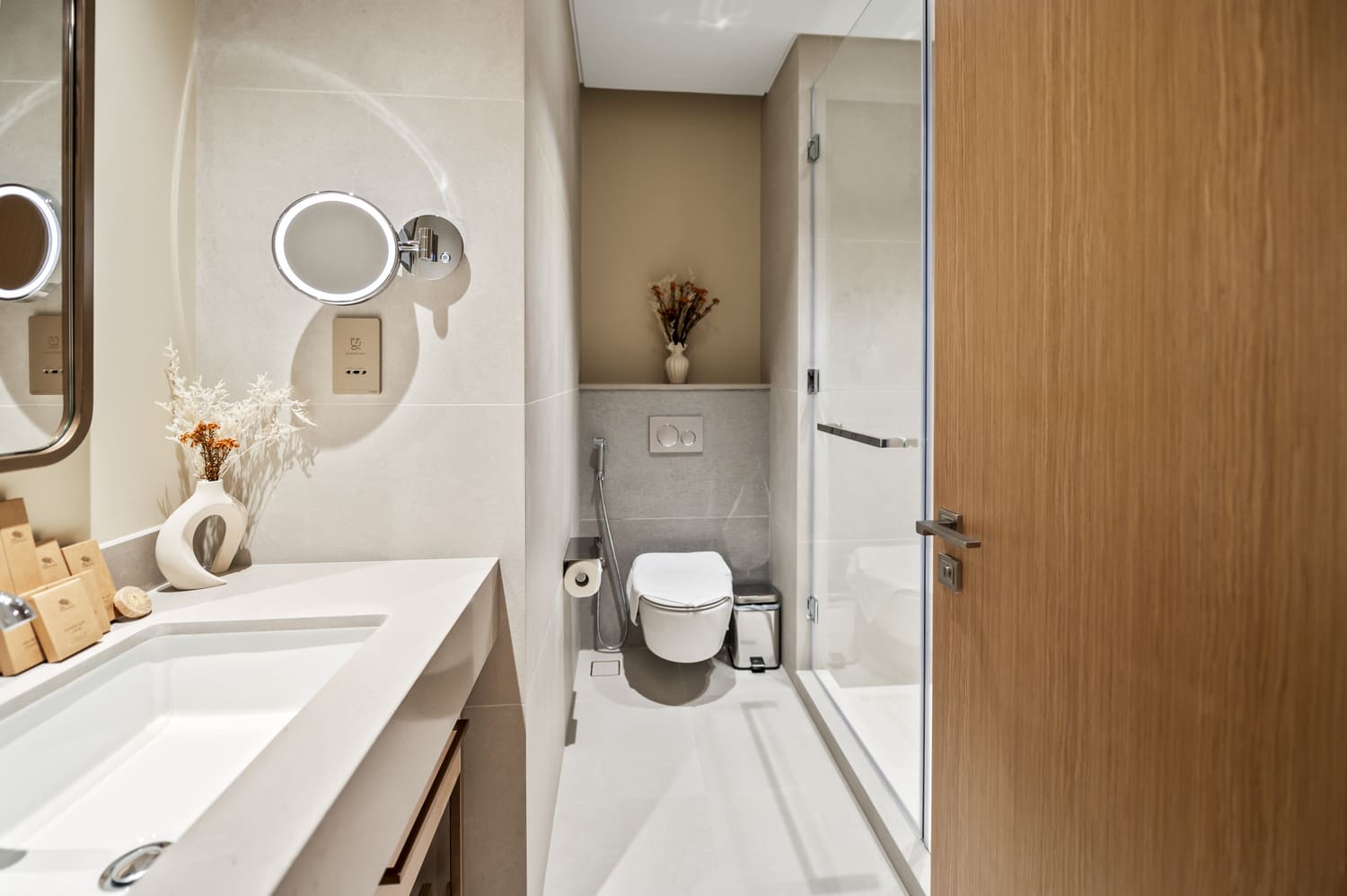 Spacious guest washroom with floating vanity and warm LED backlighting at Vida Tower 2